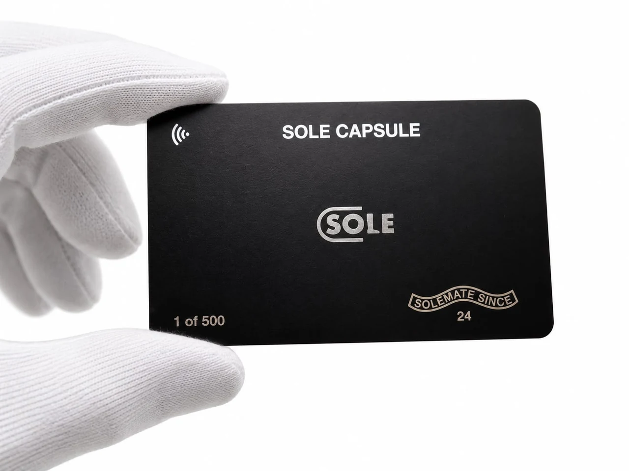 A Sole Card, numbered 1 of 500, held in a gloved hand