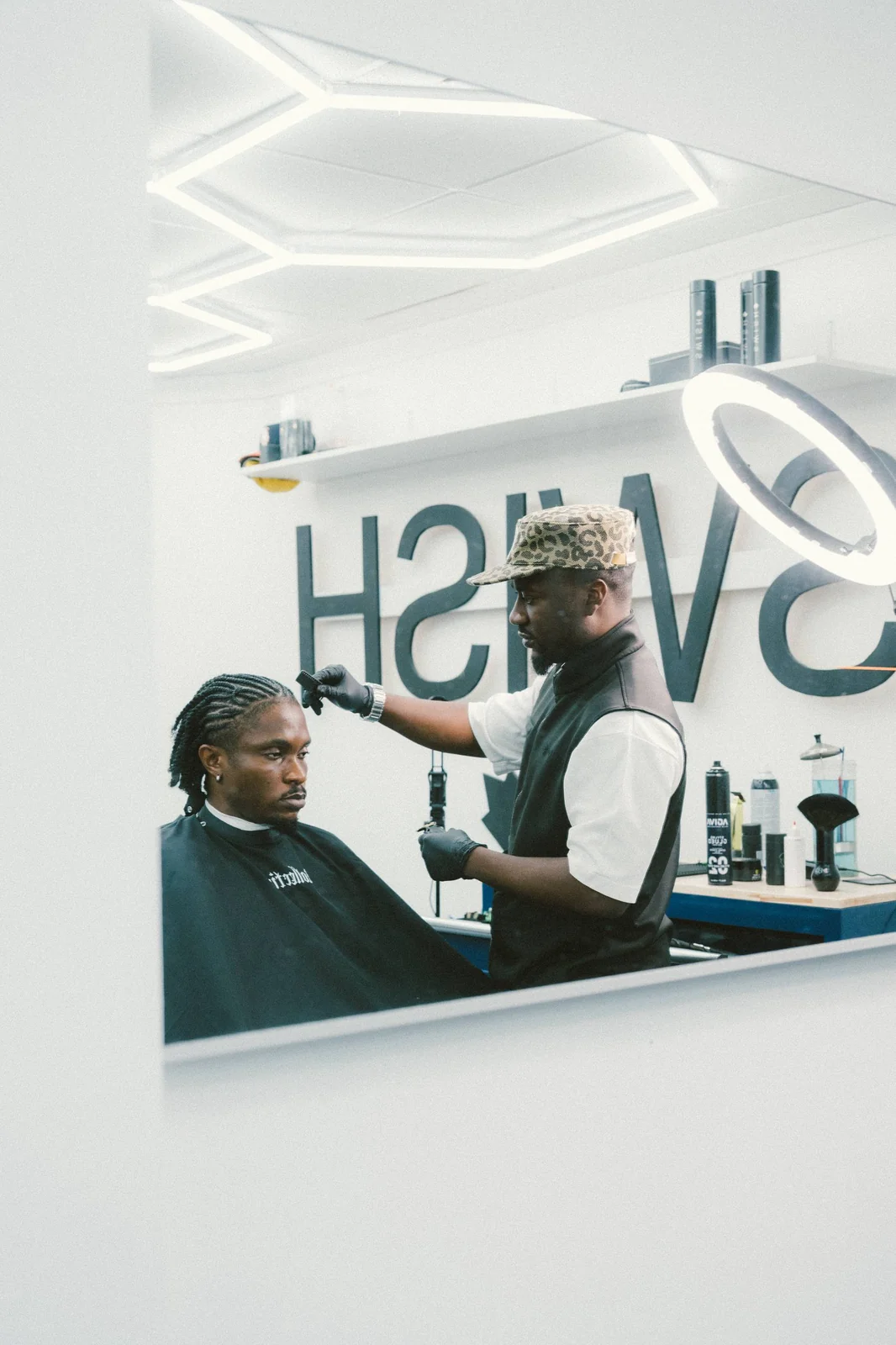 One of the founders cutting a client's hair behind the chair